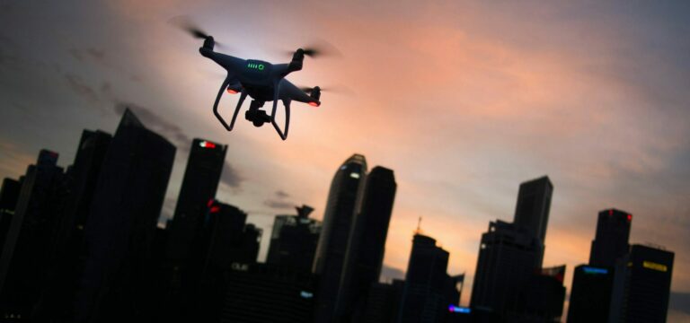 Flying a drone at dusk in the city. Picture by Goh Rhy Yan on Unsplash