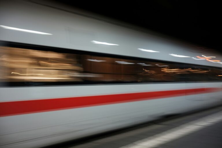 blurry picture of a high-speed train passing a station (Photo by Markus Winkler on Unsplash)